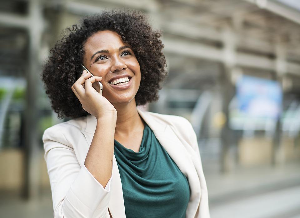 Happy businesswoman calling on smartphone.