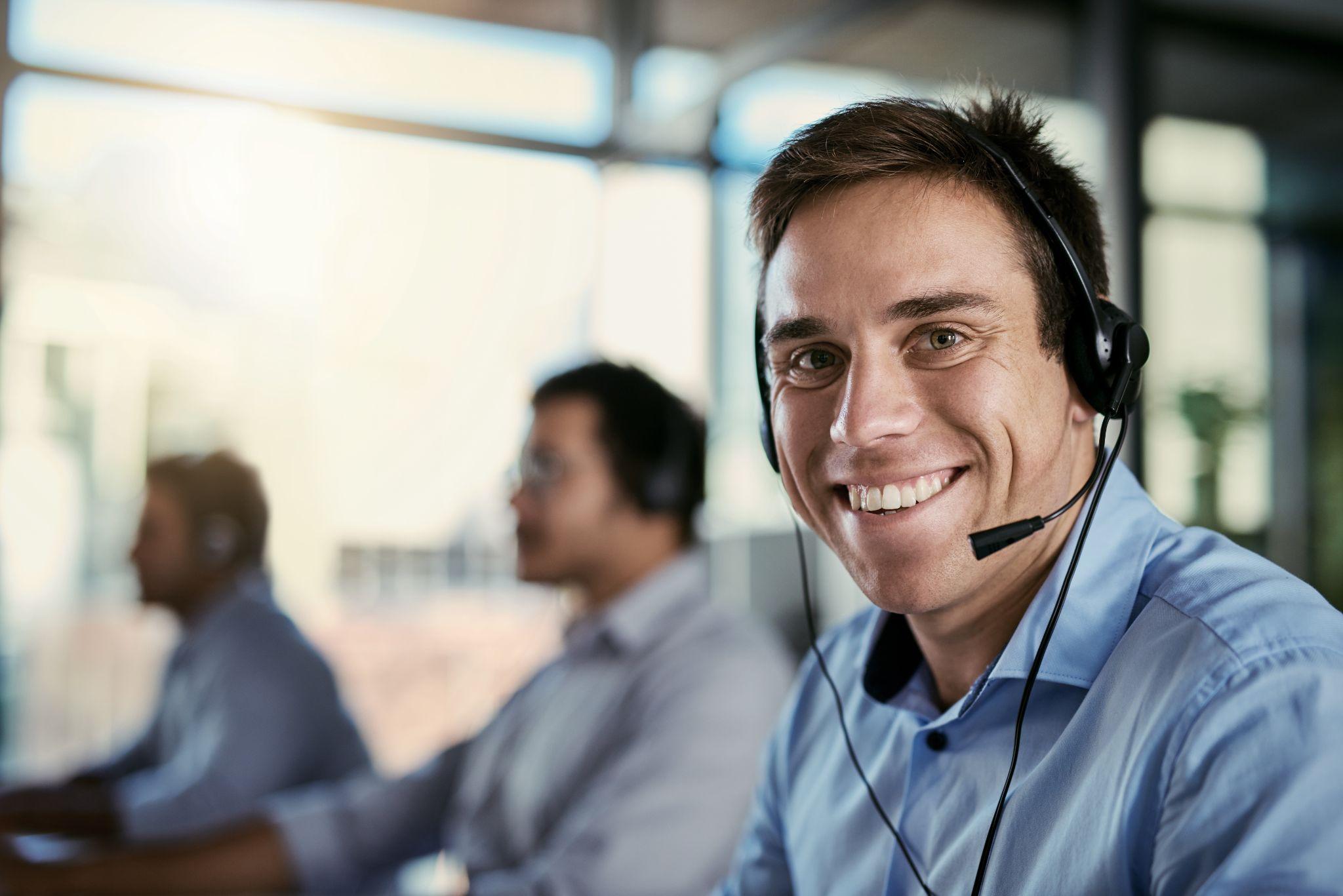 happy man in coworking space consulting with advice at help desk.